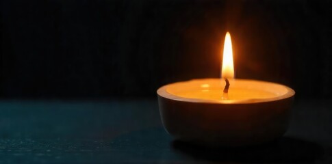 Close-up of a single candle being lit, warm yellow flame illuminating the wax, creating a soft glow against a dark background Perfect for relaxation, meditation, or spiritual themes , prayer, serene
