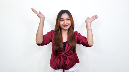 Beautiful asian woman wearing red blouse raising both hands with sweet smile expression, isolated...