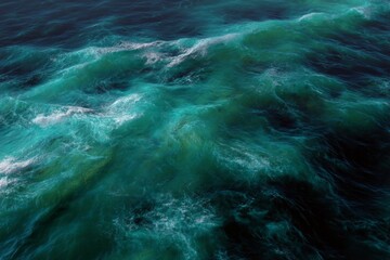 Wavey water with ripples and foam on surface.