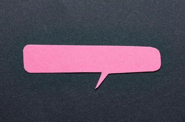 Pink cut out blank paper speech bubble of rectangular shape and rounded corners with copy space for...