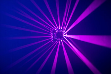 Laser beams pulsing to the rhytm of the music in an event venue