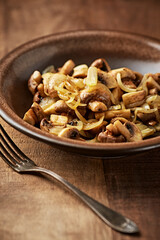 Onion with mushrooms. Rustic wooden background.	