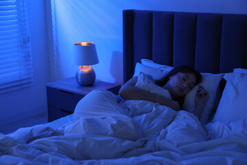 Beautiful woman sleeping in bed at home