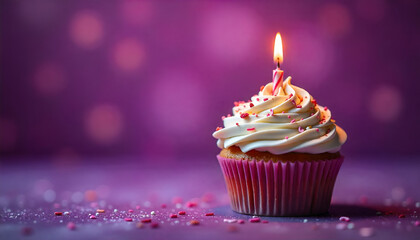 A festive cupcake with a lit candle and "Happy Birthday" text, set against a vibrant purple background&mdash;perfect for celebrating a special day.
