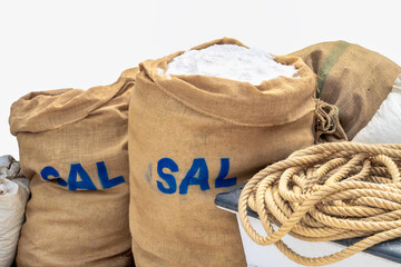 Close-up of a large jute sacks filled with coarse sea salt at a market