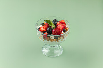 Portion of sweet appetizing layered desserd with berries