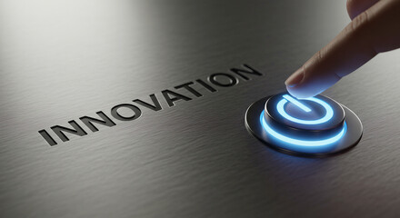 Finger pressing a blue illuminated power button next to the word innovation on a gray surface