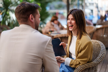 Smiling Caucasian Businesswoman and Male Colleague Collaborating Outdoors on a Sunny Day