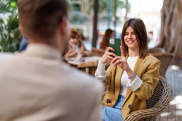 Young Entrepreneurial Caucasian Couple Collaborating Outdoors in Stylish Casual Attire and Vibrant Setting