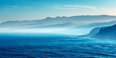 Naklejka premium Serene coastal landscape with misty mountains and ocean.