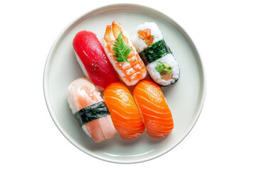 Assorted nigiri and sushi rolls served on round white plate from top view isolated on transparent background