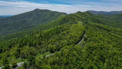 Aerial View of Twisting Mountain Road though Blue Ridge Mountains surrounded by forest 