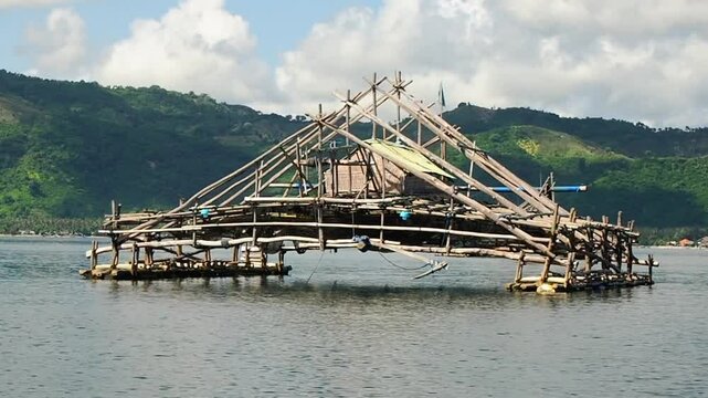 Bagan Apung or bagang is a traditional fishing structure made of bamboo for cathing anchovy in the middle of the sea. Beautiful scenery of traditional floating hut for sea fishing on the sea of Lombok