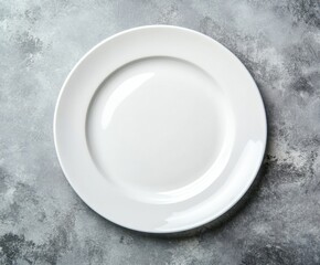 Empty white plate on grey background with copy space