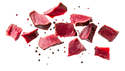 Juicy venison steak pieces and peppercorns falling on transparent background, perfect for food and recipe concepts