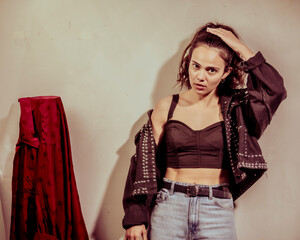 This artistic shot captures a young woman expressing her individuality through stylish attire and...