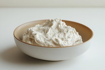 Smooth White Modeling Clay in a Ceramic Bowl on a Neutral Surface