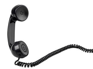 A black telephone receiver with a coiled cord against a black background in a studio setting view