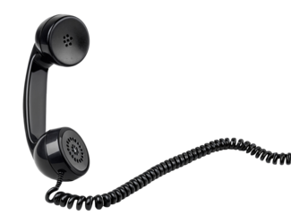 A black telephone receiver with a coiled cord against a black background in a studio setting view