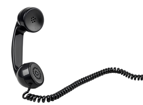 A black telephone receiver with a coiled cord against a black background in a studio setting view
