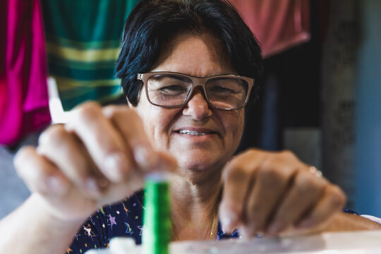 May 25th, Seamstress' Day, lady practicing the art of sewing in her home