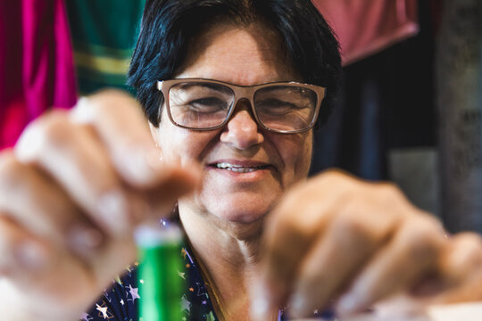 May 25th, Seamstress' Day, lady practicing the art of sewing in her home