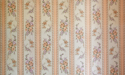 Old wallpaper on the wall. Old wallpaper for texture or background.