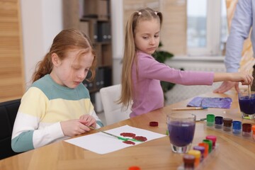 Fototapeta premium Kids with teacher at painting lesson. Learning to draw