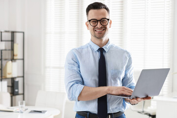 Fototapeta premium Marketing. Happy man with laptop in office, space for text