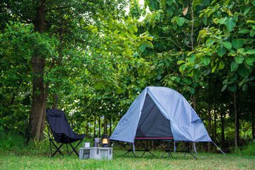 Camping tents   in a forest  and outdoor coffee-making facilities on tables 