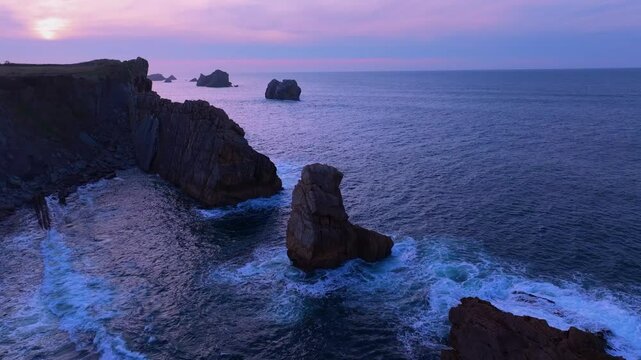 Aerial view of the sunset lights on the cliffs of Los Urros de Liencres in the Dunes of Liencres Natural Park. Pi&eacute;lagos Municipality, Costa Quebrada Geopark, Cantabrian Sea, Cantabria, Spain, Europe