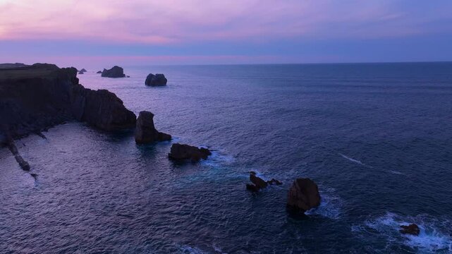 Aerial view of the sunset lights on the cliffs of Los Urros de Liencres in the Dunes of Liencres Natural Park. Pi&eacute;lagos Municipality, Costa Quebrada Geopark, Cantabrian Sea, Cantabria, Spain, Europe