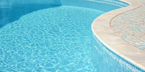 Close Up View of Curved Blue Pool Edge with Mosaic Tile Detail for Resort Marketing Imagery
