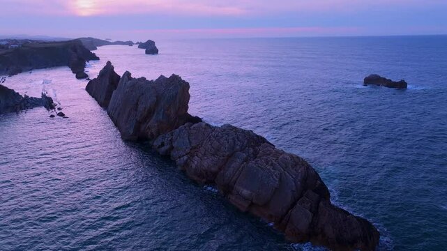 Aerial view of the sunset lights on the cliffs of Los Urros de Liencres in the Dunes of Liencres Natural Park. Pi&eacute;lagos Municipality, Costa Quebrada Geopark, Cantabrian Sea, Cantabria, Spain, Europe