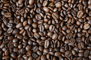 Close-up view of roasted coffee beans showcasing rich textures and colors, highlighting the natural beauty of coffee for culinary and beverage enthusiasts