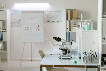 Modern laboratory setup featuring advanced scientific equipment and detailed diagrams on display showcasing scientific research and data analysis