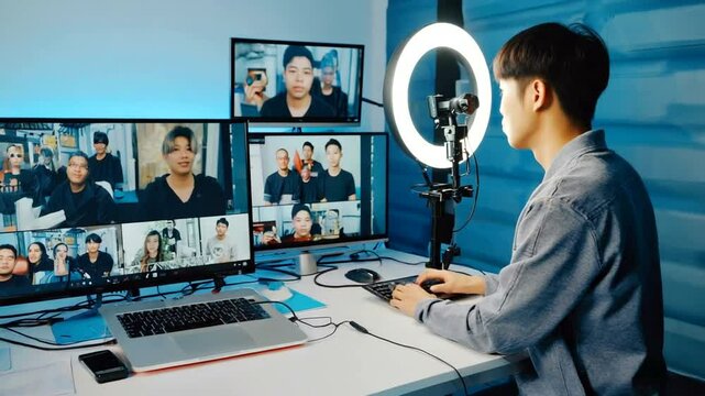 Young man engaged in live streaming session with multiple screens displaying participants