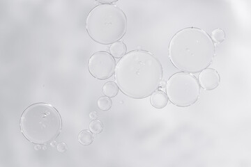 Transparent skincare serum texture with air bubbles on light background