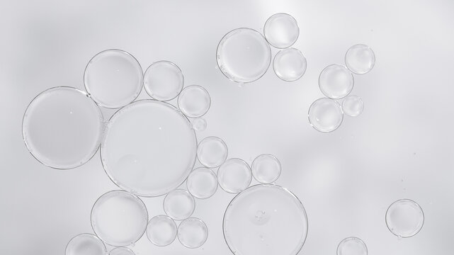 Transparent skincare serum texture with air bubbles on light background