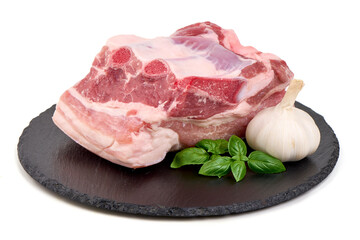 Raw Pork Chop with Garlic on Slate Plate, Isolated on White Background.