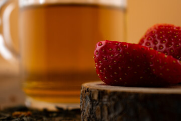 inviting close-up features a glass of green tea alongside vibrant strawberries, evoking a sense of...