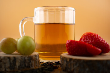 a glass of green tea, fresh strawberries, and juicy grapes, evoking a feeling of healthy indulgence...