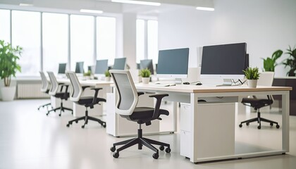 Clean modern coworking space with computer workstations and ergonomic chairs