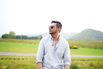 Handsome man entrepreneur standing in front organic vineyard.