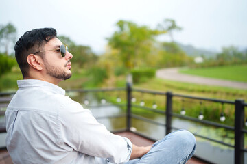 Handsome man entrepreneur looking at his organic vineyard.