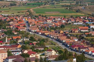 Aerial view of the town center with hills, buildings, streets, vegetation and surroundings in...