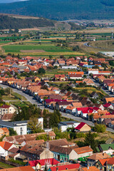 Obraz premium Aerial view of the town center with hills, buildings, streets, vegetation and surroundings in Rupea, Romania, 2021
