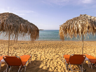 Straw umbrellas and sunbeds on sandy beach, Sunny day at sea. Summer holidays