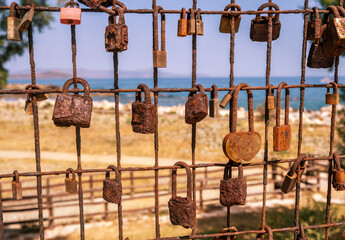 Love lock. Rusty padlocks on metal fence grid, closeup. Love and commitment concept