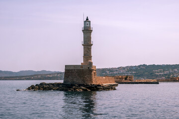 Chania Crete. Lighthouse at old venetian harbor, blue cloudy sky